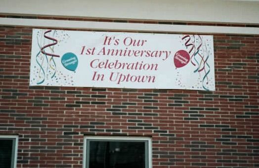 Uptown.  Outdoor banner announcing an event. 