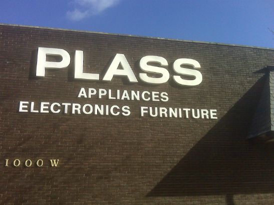 Plass.  Dimensional letters on a building facade. 
