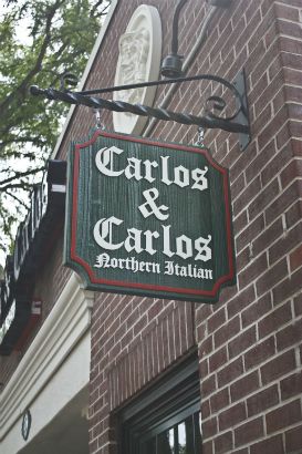 Carlos & Carlos Arlington Heights.  Hanging sandblasted sign with raised painted logo and wrought iron post.