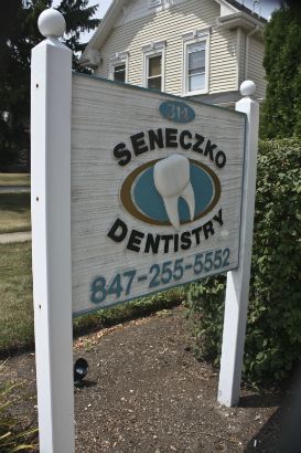 Seneczko Dentistry Arlington Heights.  The background is sandblasted, raised painted letters look professional and clean. 
