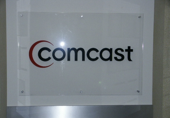 Comcast.  Logo in vinyl on acrylic plaque.