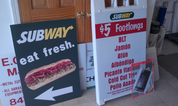 Directional Cor-x sign featuring a high resolution photo of a sandwich.